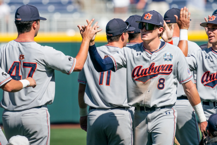 auburn baseball uniforms under armour green camo hat cap sec butch thompson omaha college world series